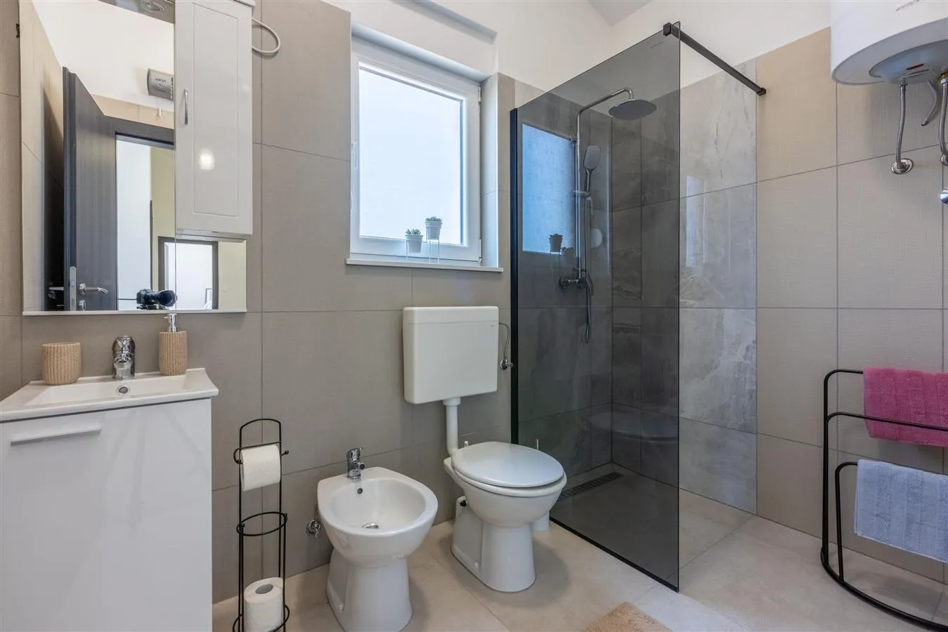 Modern bathroom with glass shower and bidet