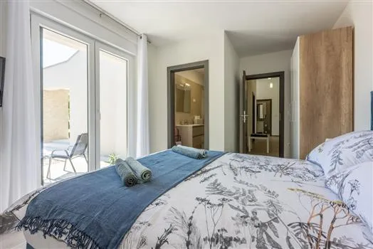 Modern bedroom with patio doors and ensuite bathroom