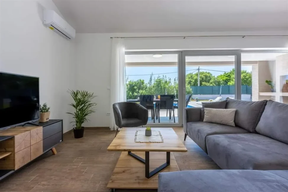 Modern living room with patio and pool view