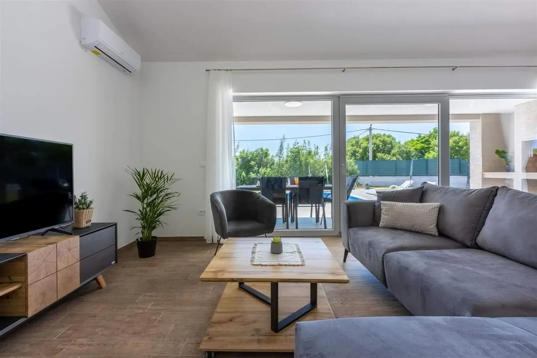 Modern living room with patio and pool view