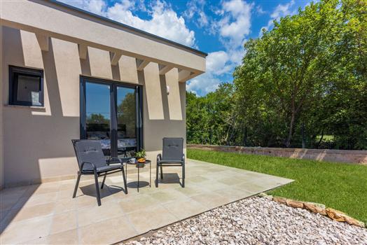 Modern patio with chairs and garden view