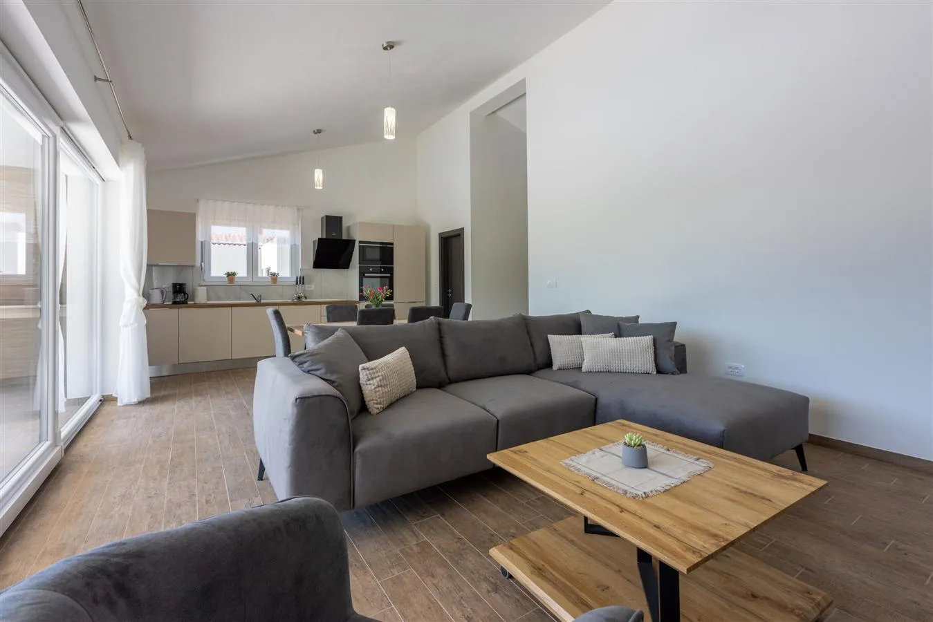 Modern open-plan living room with gray sectional sofa