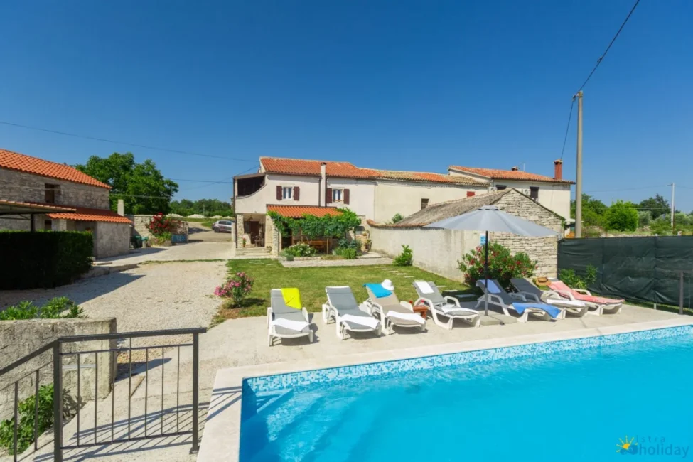 Stone house with pool and sun loungers