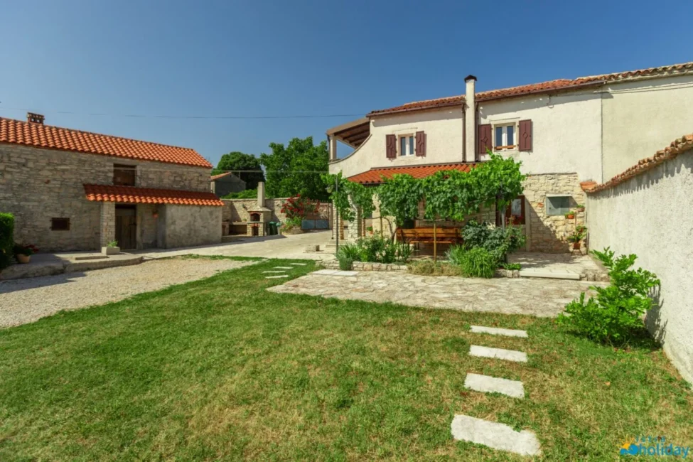 Stone house with garden and red-tiled roof
