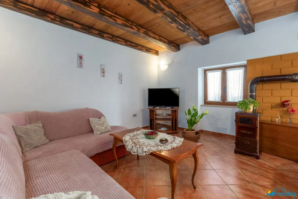 Cozy living room with pink couch and TV.