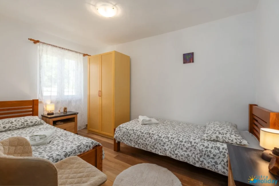 Cozy bedroom with two single beds and wardrobe.