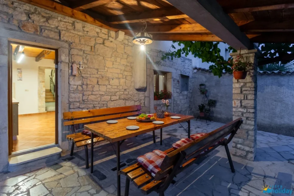 Cozy outdoor dining area with wooden benches.