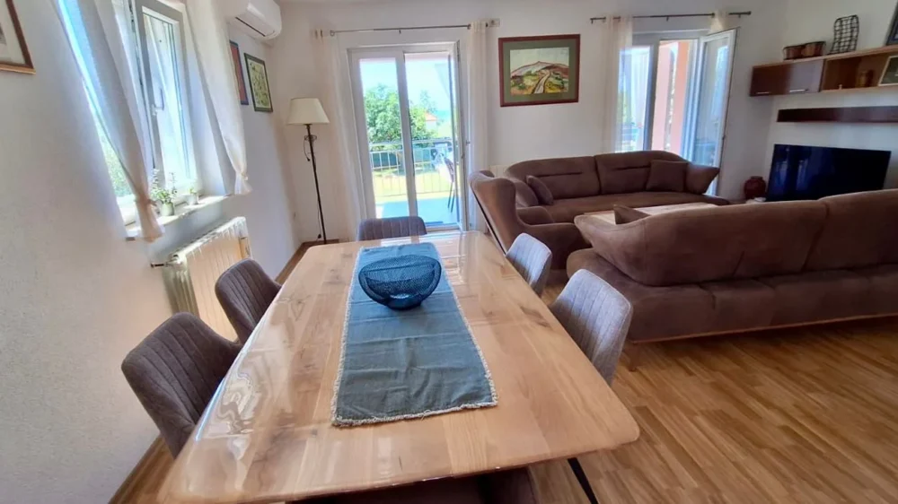 Bright living room with dining table and sofas