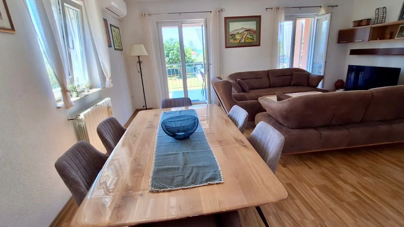 Bright living room with dining table and sofas