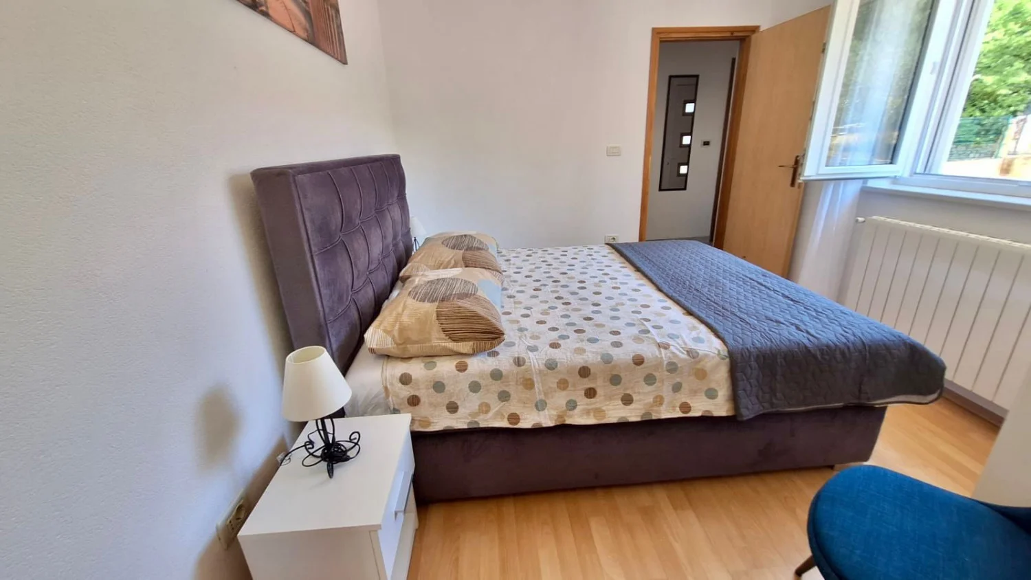 Cozy bedroom with double bed and window