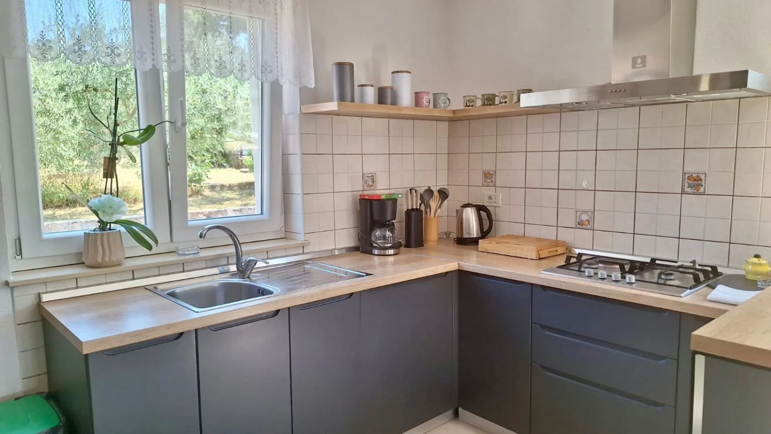 Modern kitchen with wooden countertops and window sink