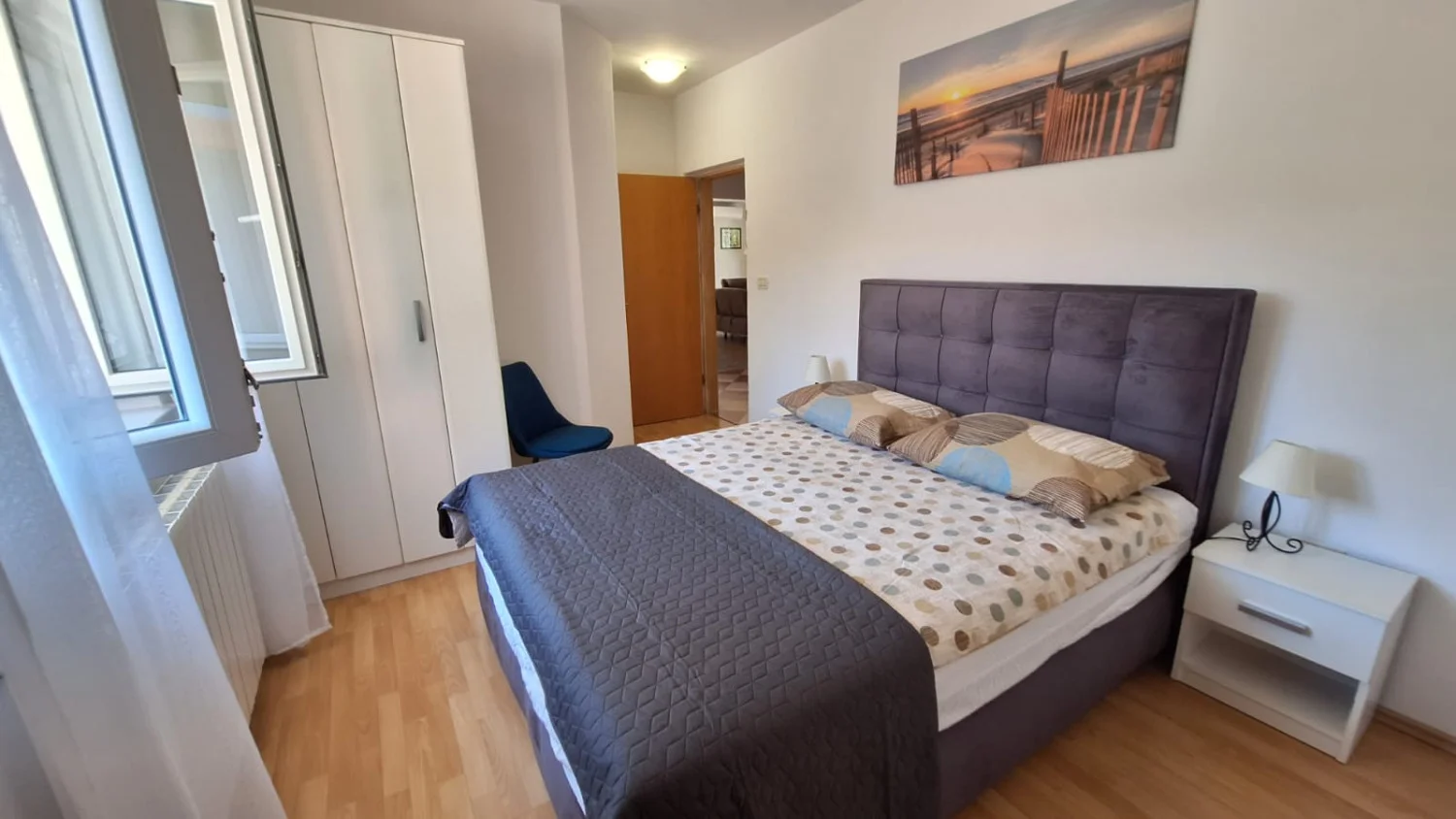 Modern bedroom with double bed and wardrobe