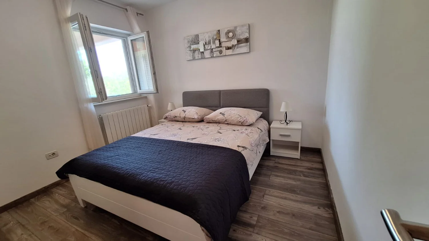 Modern minimalist bedroom with double bed and window