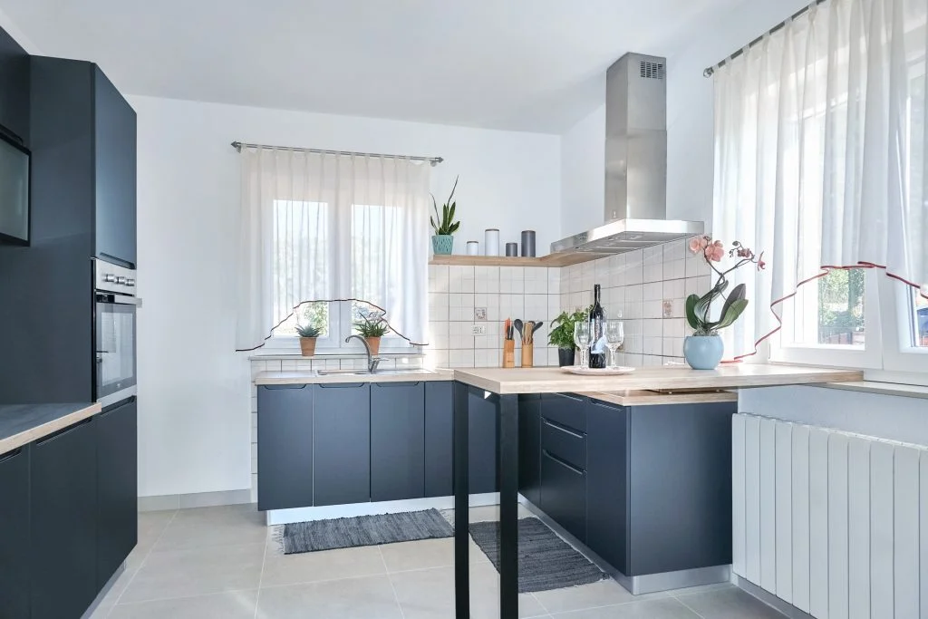 Modern kitchen with blue cabinets and wood countertops